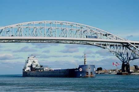 The freighter Algolake passing beneath the Blue Water Bridge on the St. Clair River